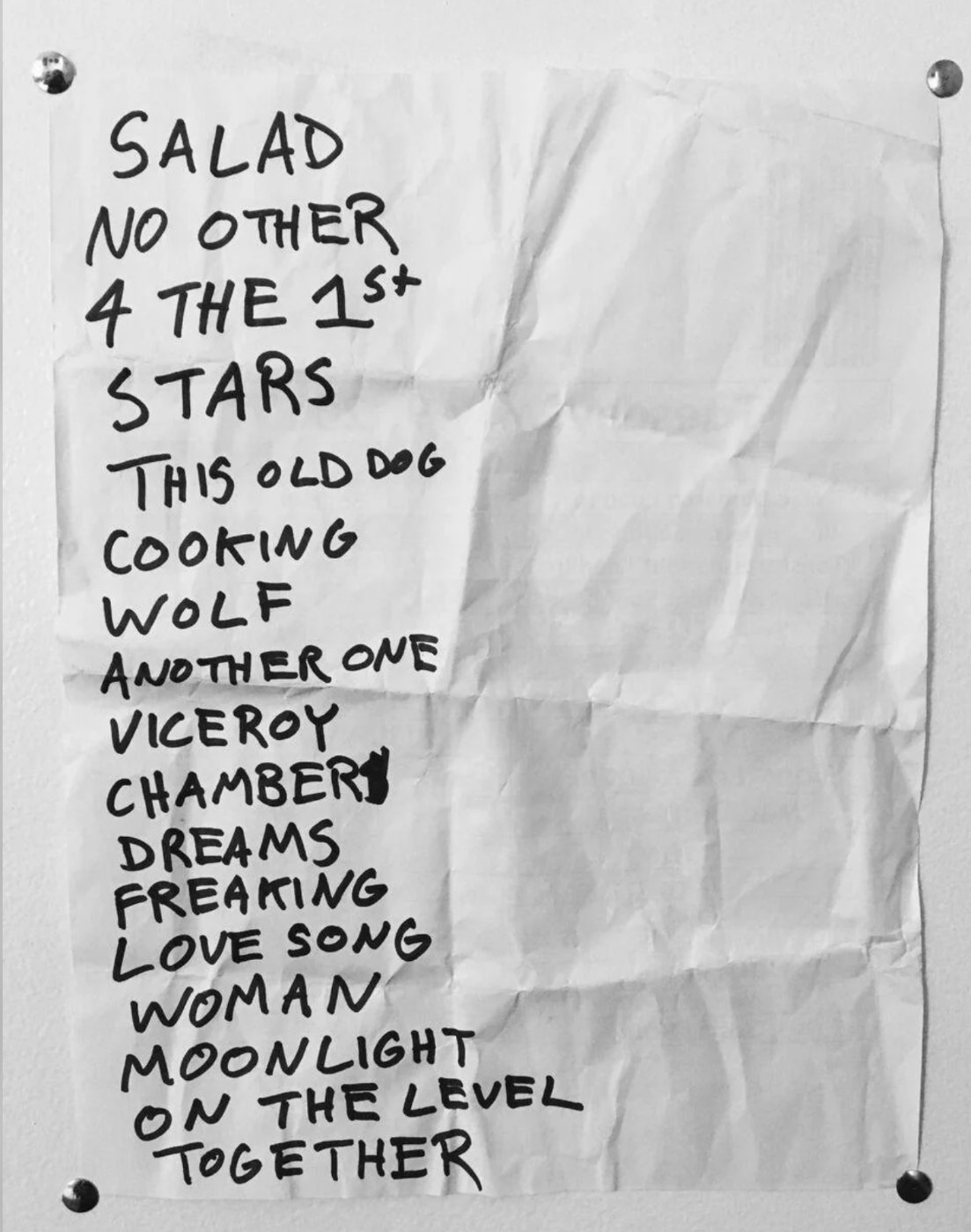 A handwritten setlist pinned to a wall, bold marker song titles, the kind of sheet you photograph to import into Setcraft